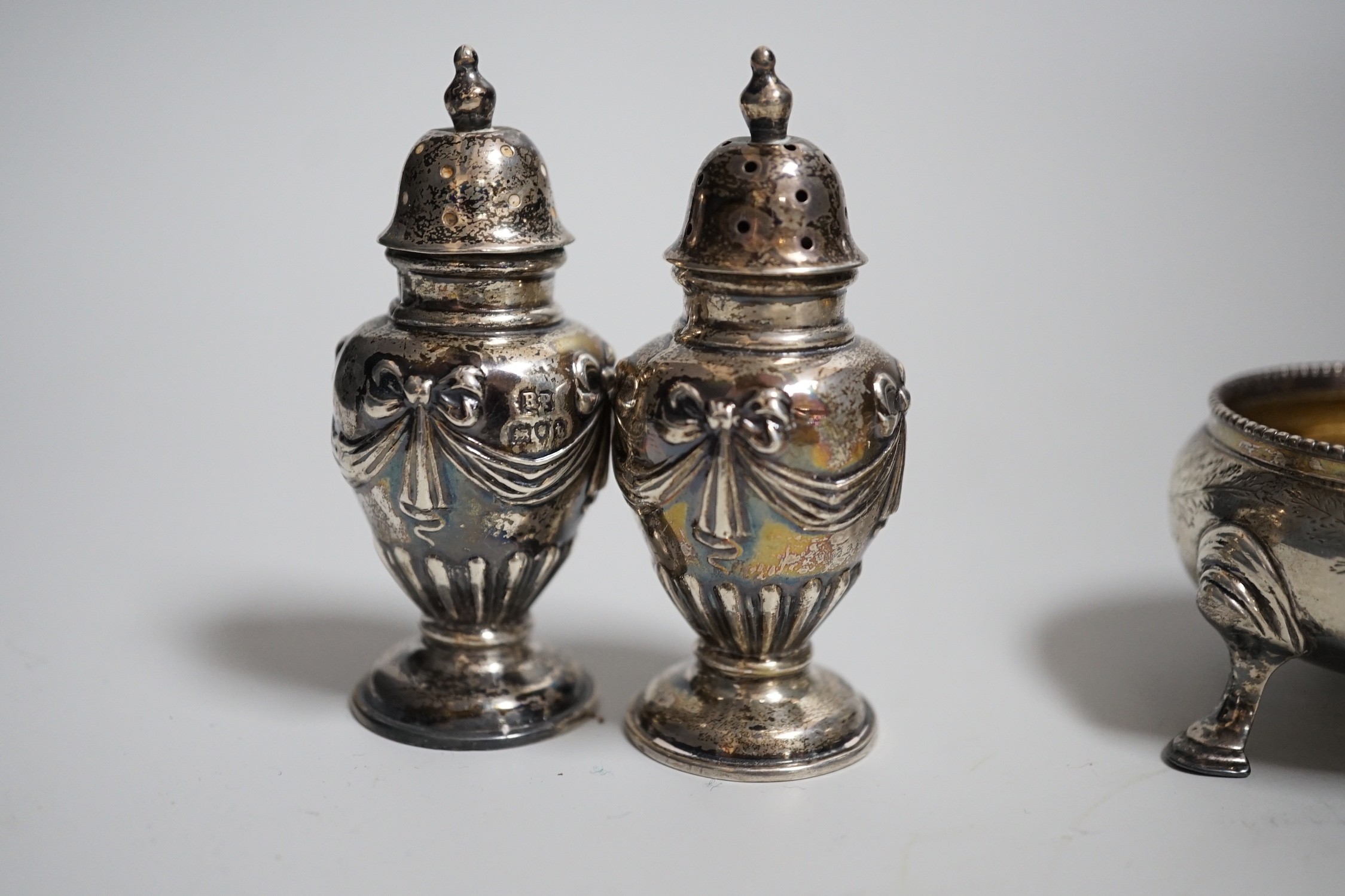 A pair of Victorian silver bun salts, London, 1868, diameter 5cm and a pair of Victorian silver peppers.